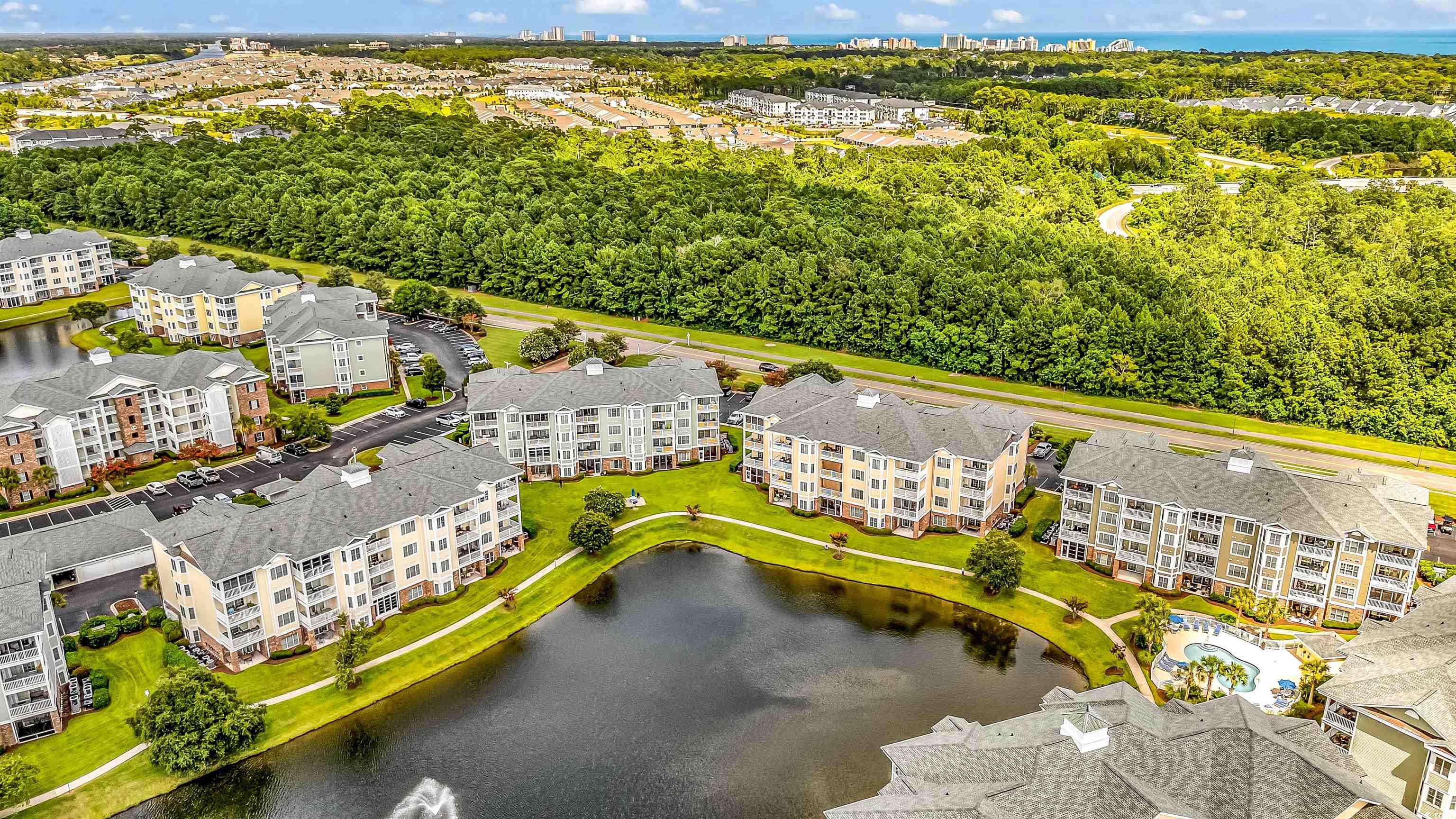 4829 Luster Leaf Circle, Unit 301 Myrtle Beach, SC 29577 - Photo 6 of 34 Bird's eye view of a large body of water and a tree filled landscape