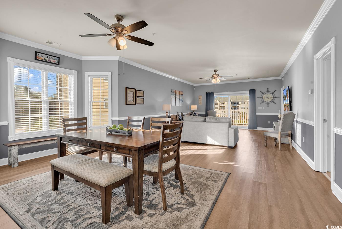 4829 Luster Leaf Circle, Unit 301 Myrtle Beach, SC 29577 - Photo 9 of 34 Dining room with crown molding, light wood-style floors, and ceiling fan