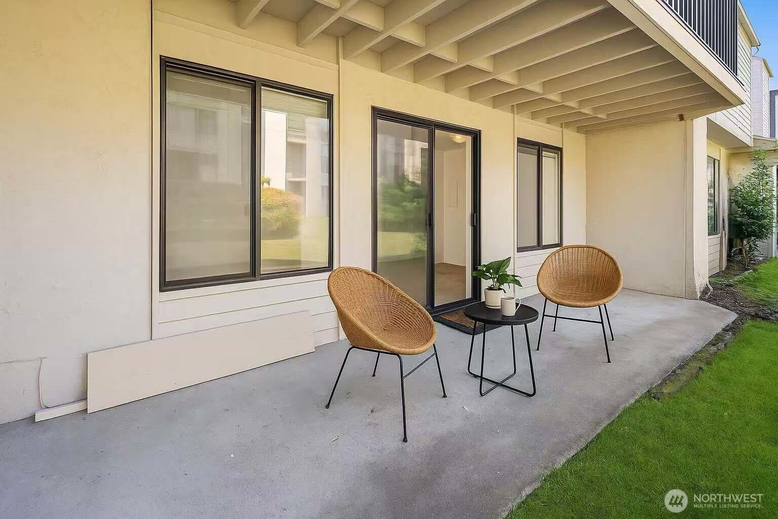 12424 Northeast 145th Street, Unit C25 Kirkland, WA 98034 - Photo 11 of 40 a view of a chair and tables in the back yard of a house
