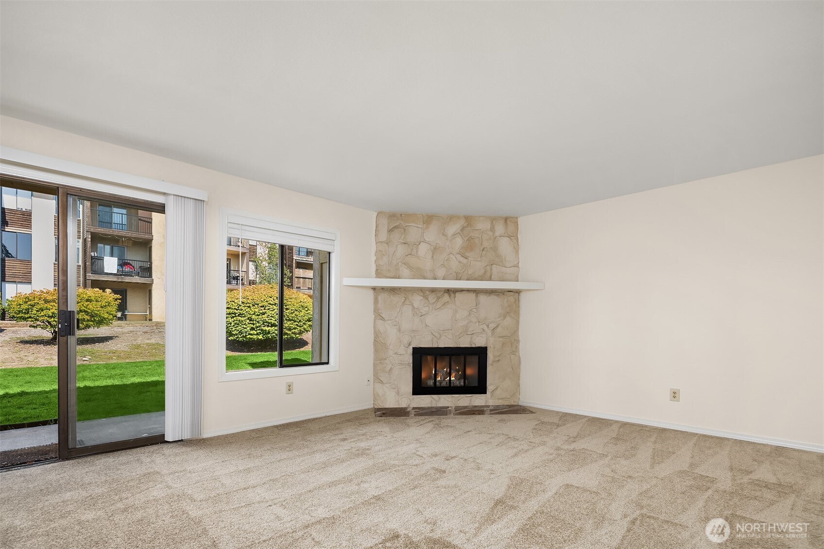 12424 Northeast 145th Street, Unit C25 Kirkland, WA 98034 - Photo 13 of 40 an empty room with floor to ceiling window and an empty room
