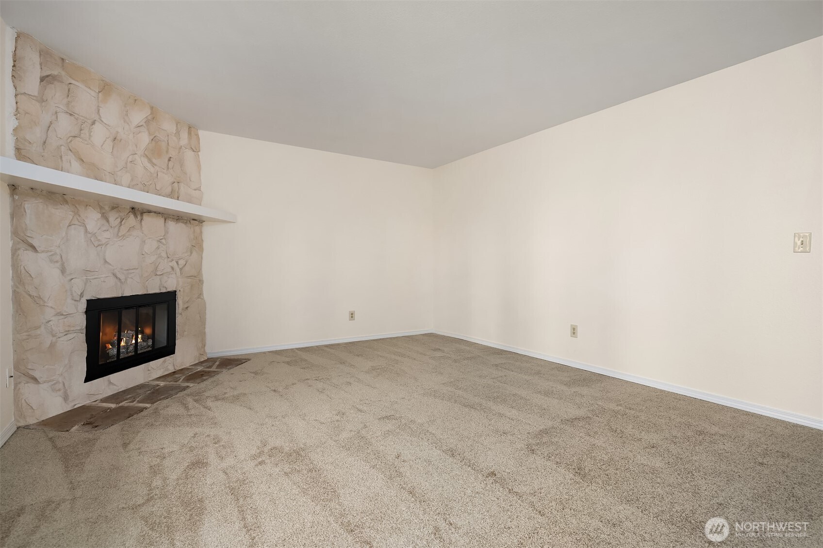 12424 Northeast 145th Street, Unit C25 Kirkland, WA 98034 - Photo 14 of 40 a view of an empty room with a fireplace