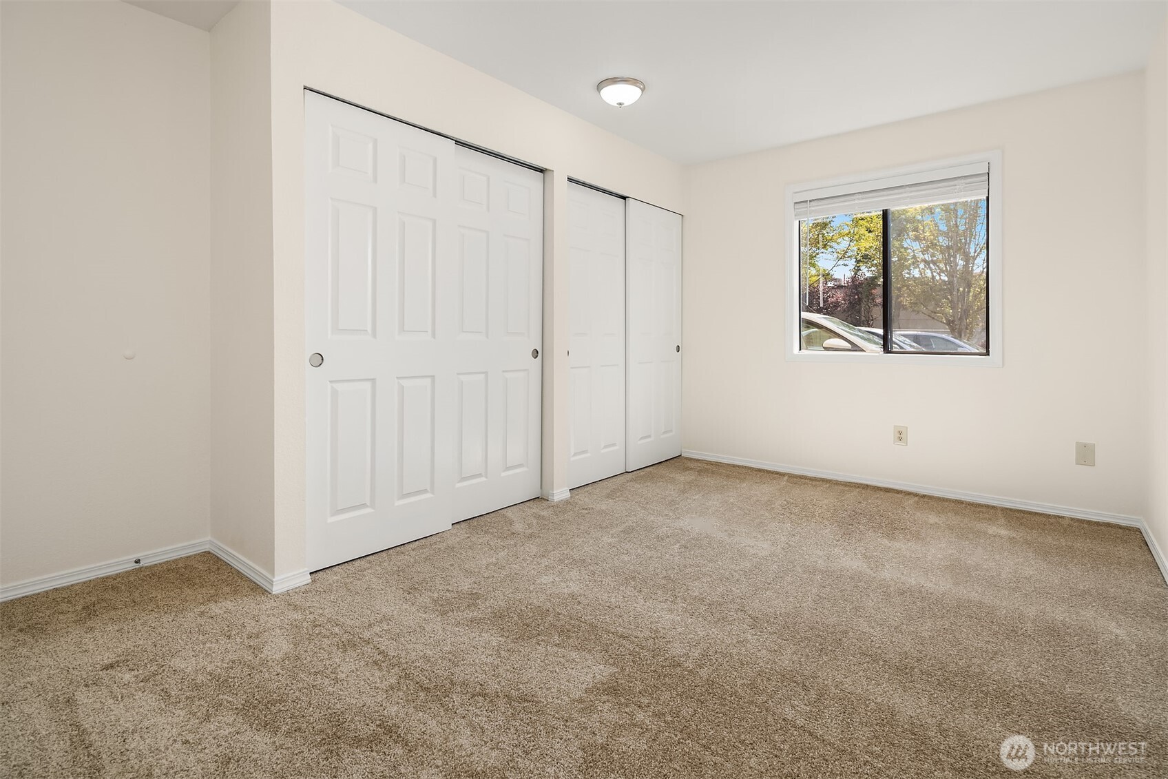 12424 Northeast 145th Street, Unit C25 Kirkland, WA 98034 - Photo 23 of 40 a view of an empty room with windows