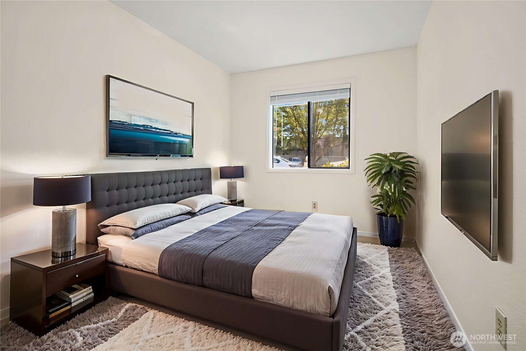 12424 Northeast 145th Street, Unit C25 Kirkland, WA 98034 - Photo 8 of 40 a bedroom with a bed and a flat screen tv