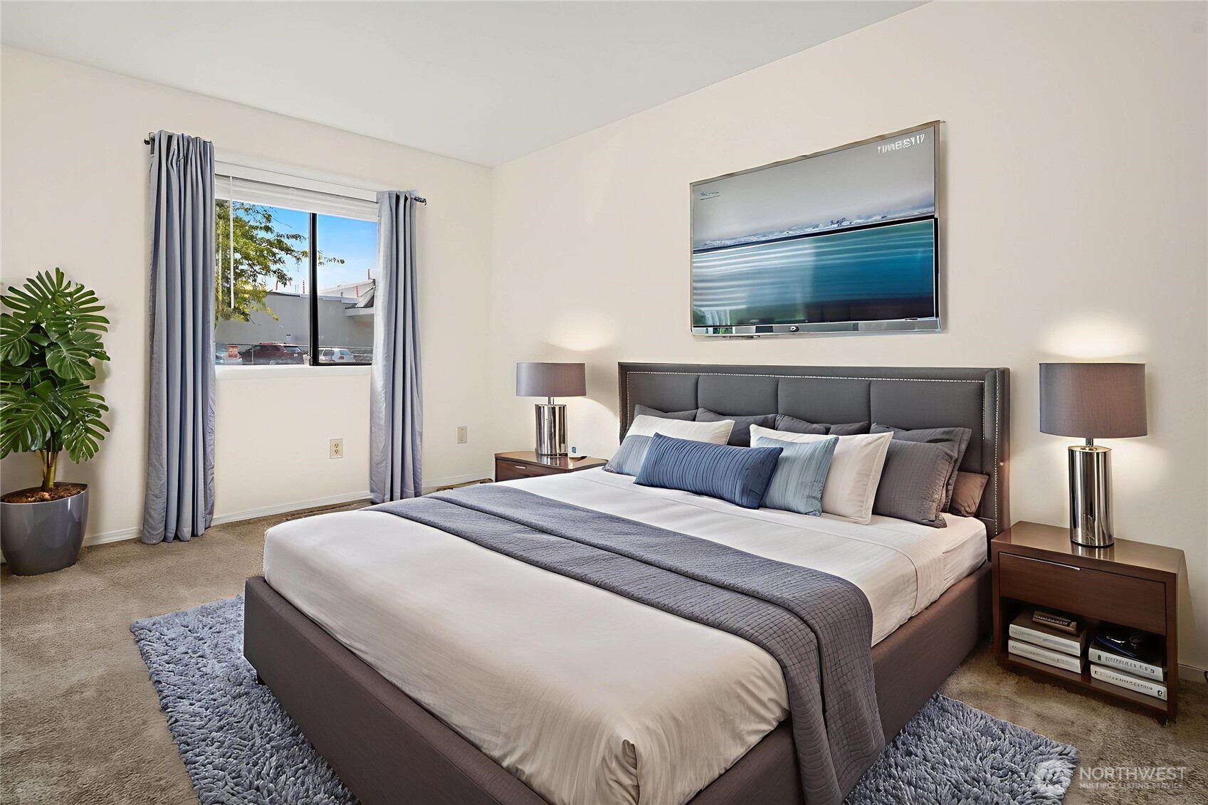 12424 Northeast 145th Street, Unit C25 Kirkland, WA 98034 - Photo 9 of 40 a bedroom with a bed and a flat screen tv