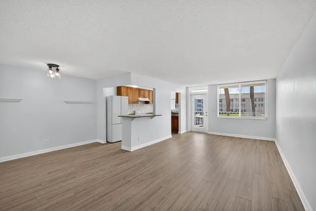a view of kitchen with wooden floor electronic appliances and window
