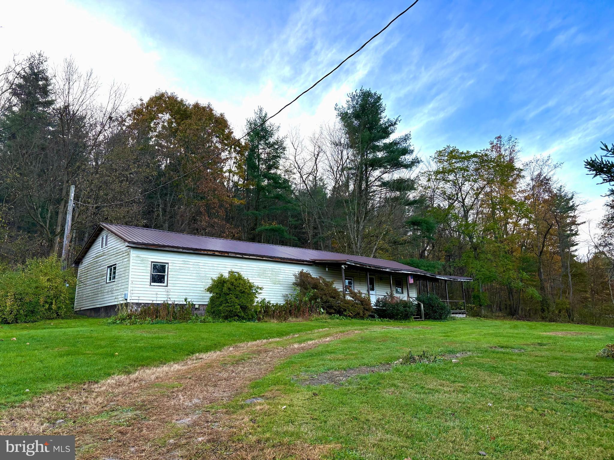 127 Evergreen Road Blanchard, PA 16826 - Photo 2 of 14 a view of house with backyard and garden