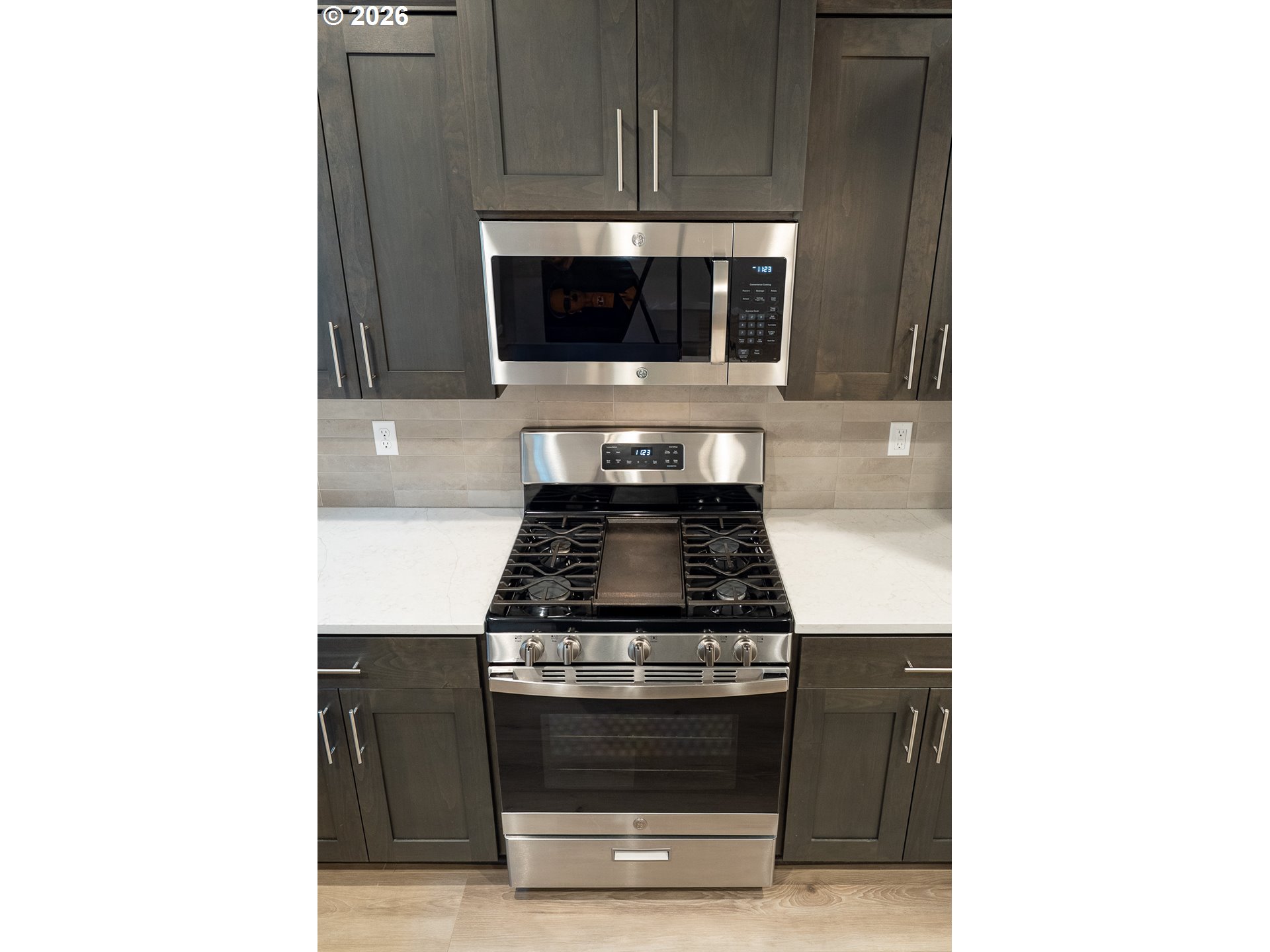 10495 Southeast Heritage Road Happy Valley, OR 97086 - Photo 16 of 46 a stove top oven sitting inside of a kitchen