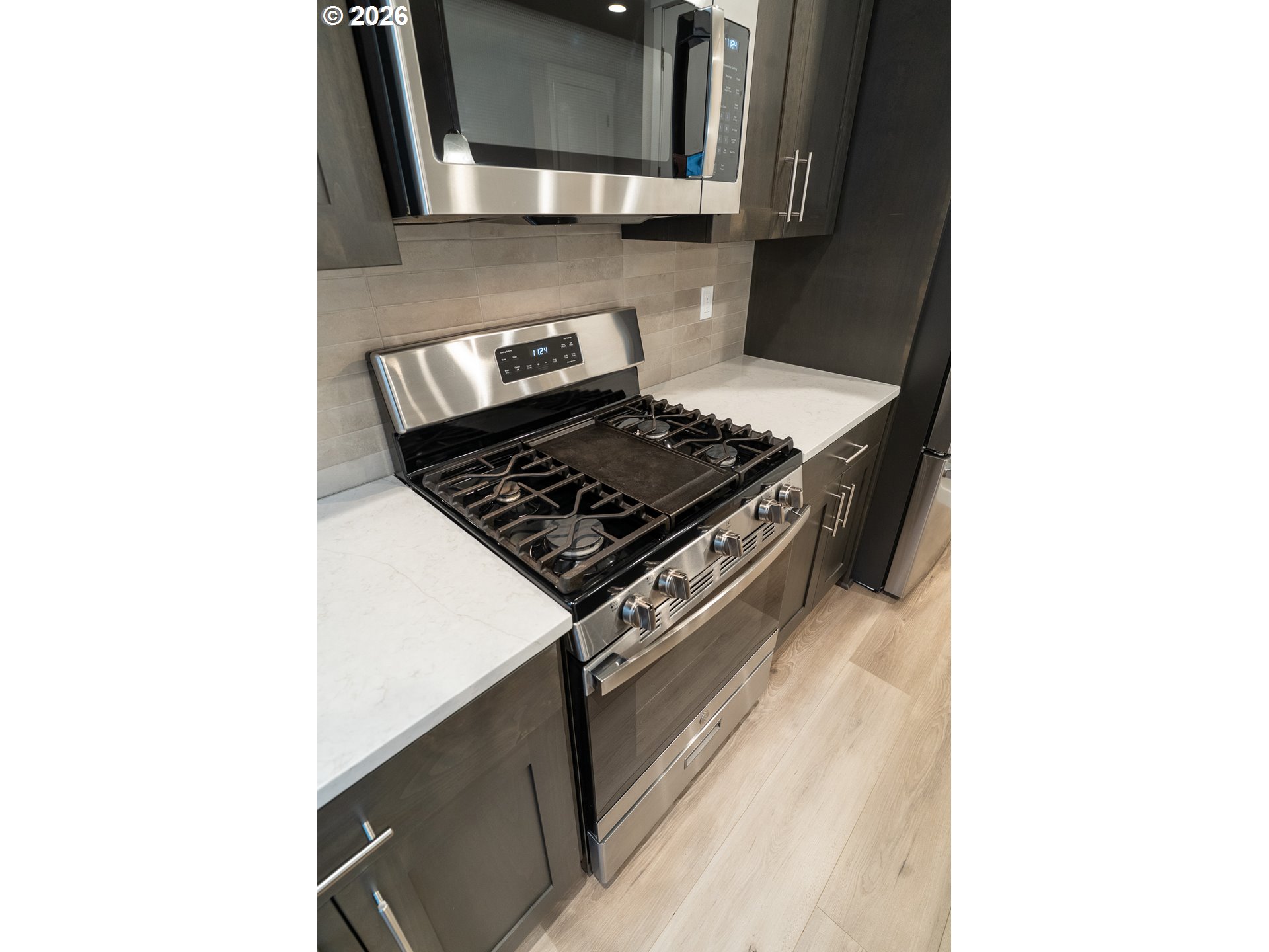 10495 Southeast Heritage Road Happy Valley, OR 97086 - Photo 18 of 46 a stove top oven sitting inside of a kitchen