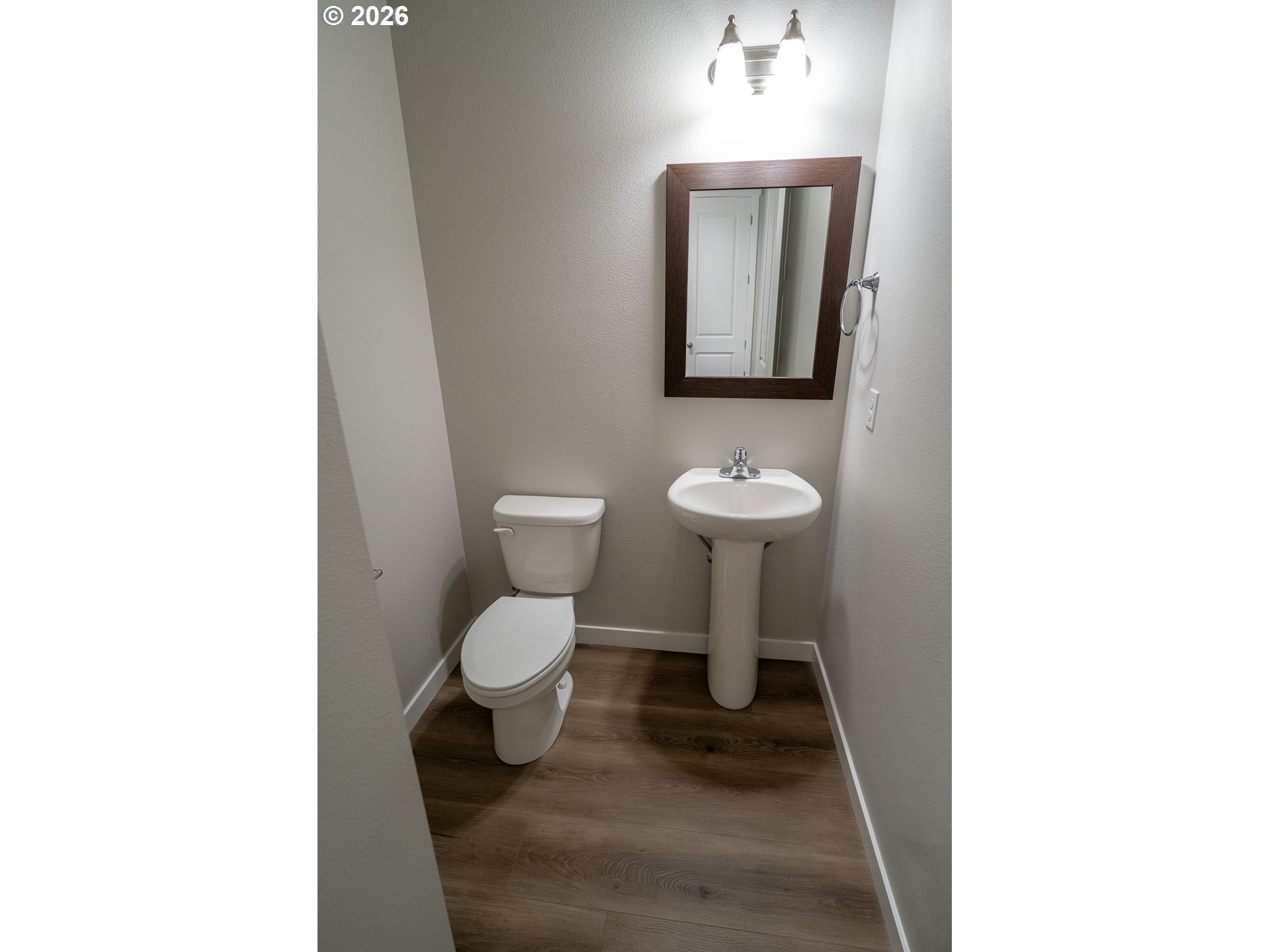 10495 Southeast Heritage Road Happy Valley, OR 97086 - Photo 19 of 46 a bathroom with a toilet sink and mirror