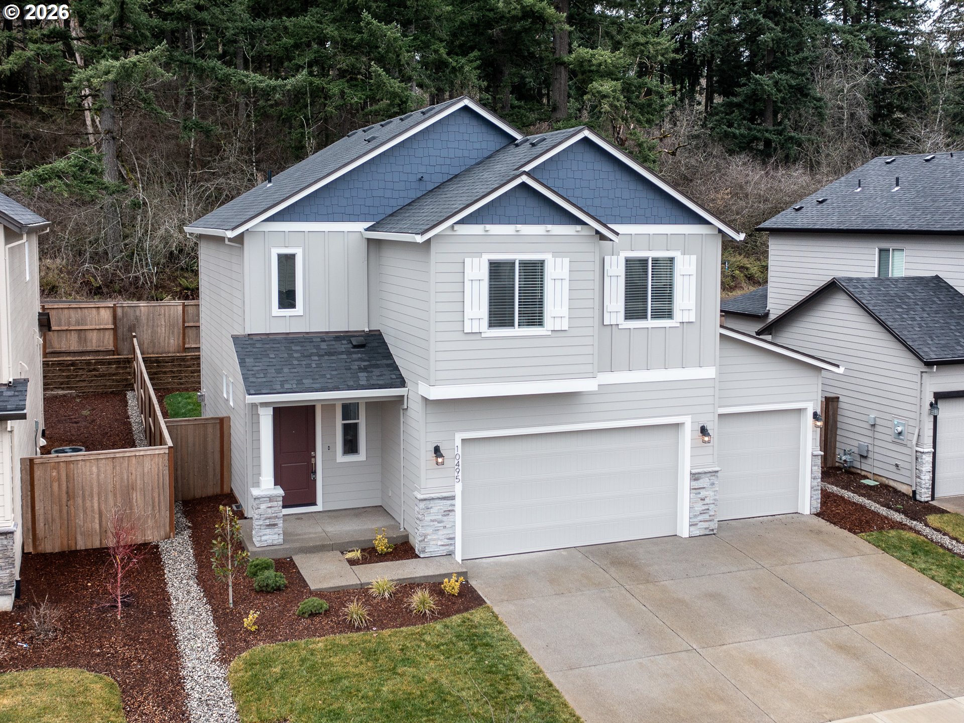 10495 Southeast Heritage Road Happy Valley, OR 97086 - Photo 2 of 46 a front view of a house with a yard