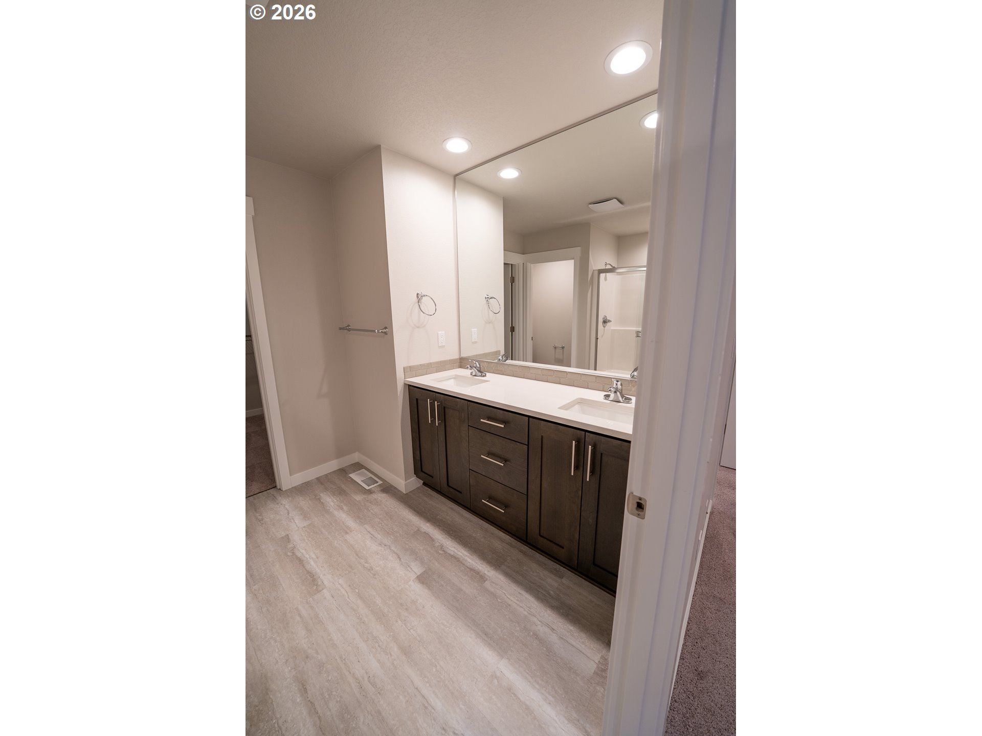 10495 Southeast Heritage Road Happy Valley, OR 97086 - Photo 28 of 46 a spacious bathroom with a double vanity sink and a mirror