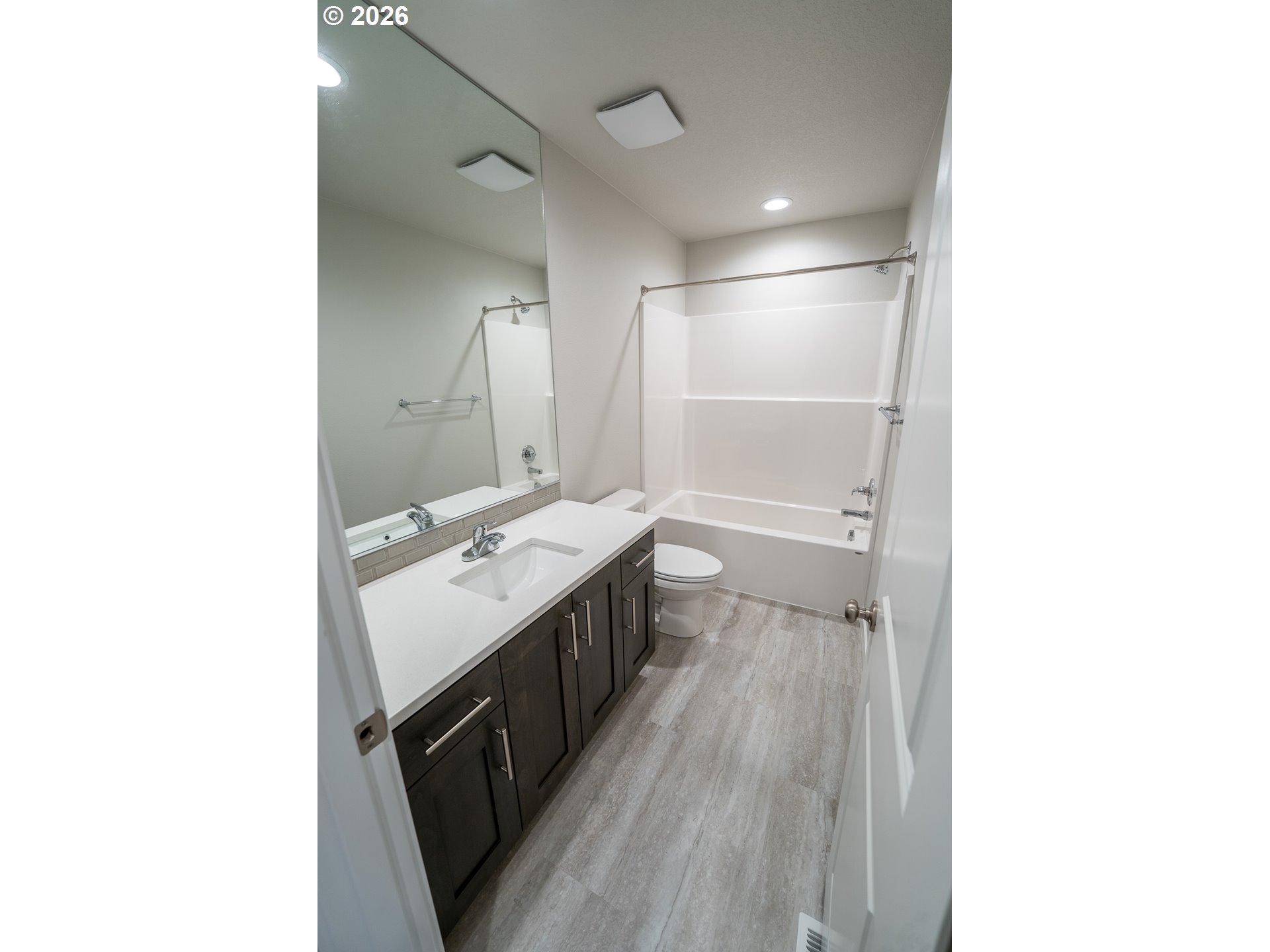 10495 Southeast Heritage Road Happy Valley, OR 97086 - Photo 34 of 46 a bathroom with a sink a toilet and a mirror