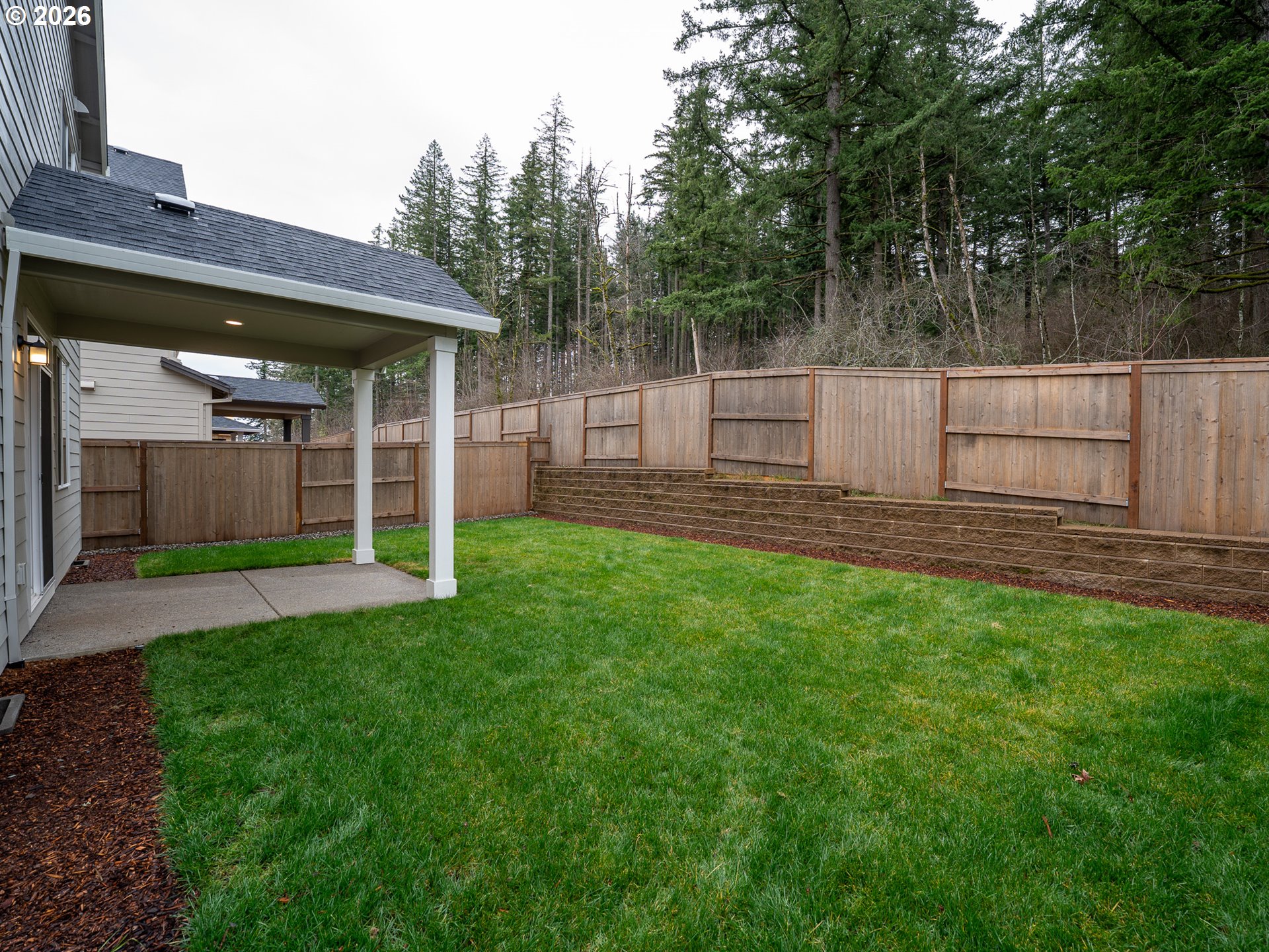 10495 Southeast Heritage Road Happy Valley, OR 97086 - Photo 40 of 46 a view of a backyard with a large tree