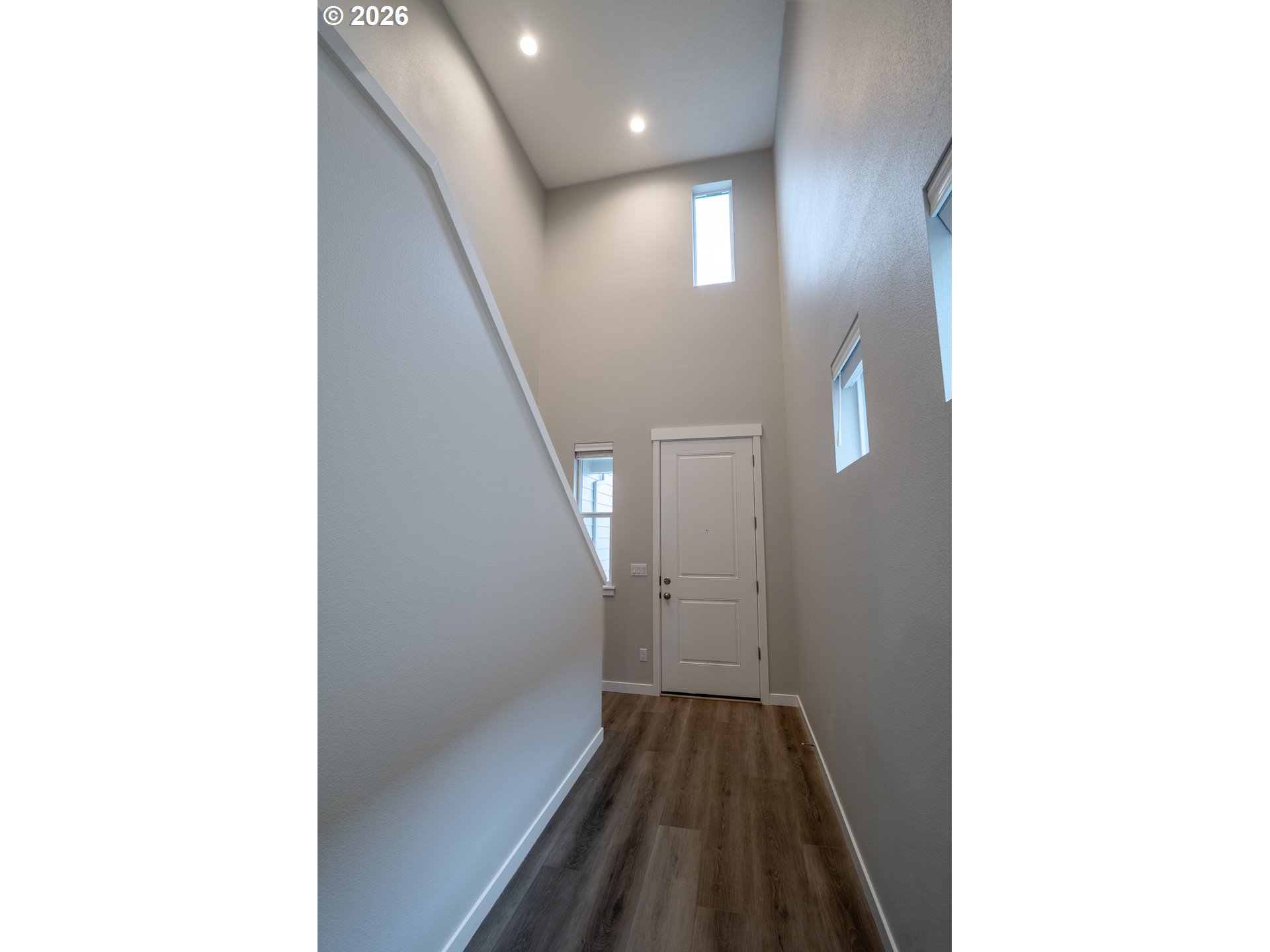10495 Southeast Heritage Road Happy Valley, OR 97086 - Photo 5 of 46 a view of a hallway with wooden floor