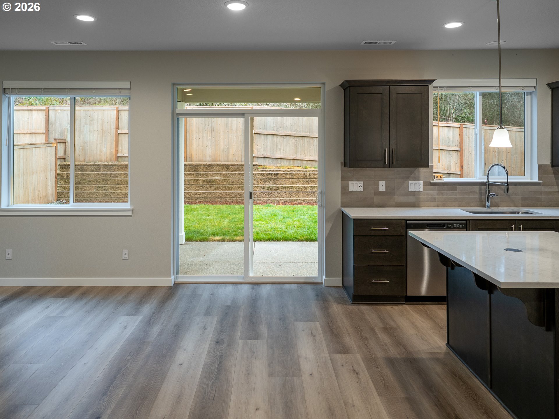 10495 Southeast Heritage Road Happy Valley, OR 97086 - Photo 9 of 46 a kitchen with wooden floors and a sink