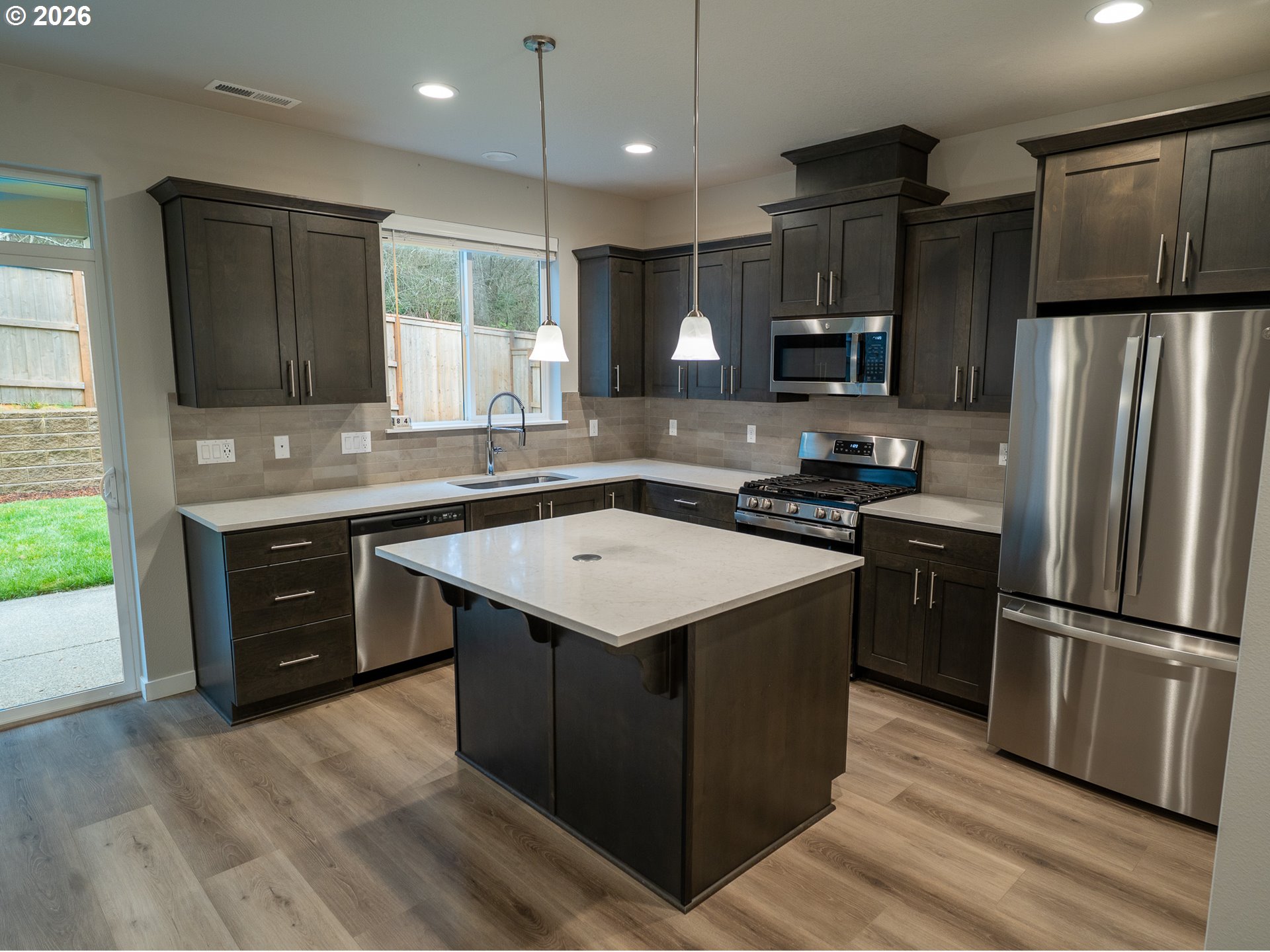10495 Southeast Heritage Road Happy Valley, OR 97086 - Photo 10 of 46 a kitchen with a refrigerator sink and microwave