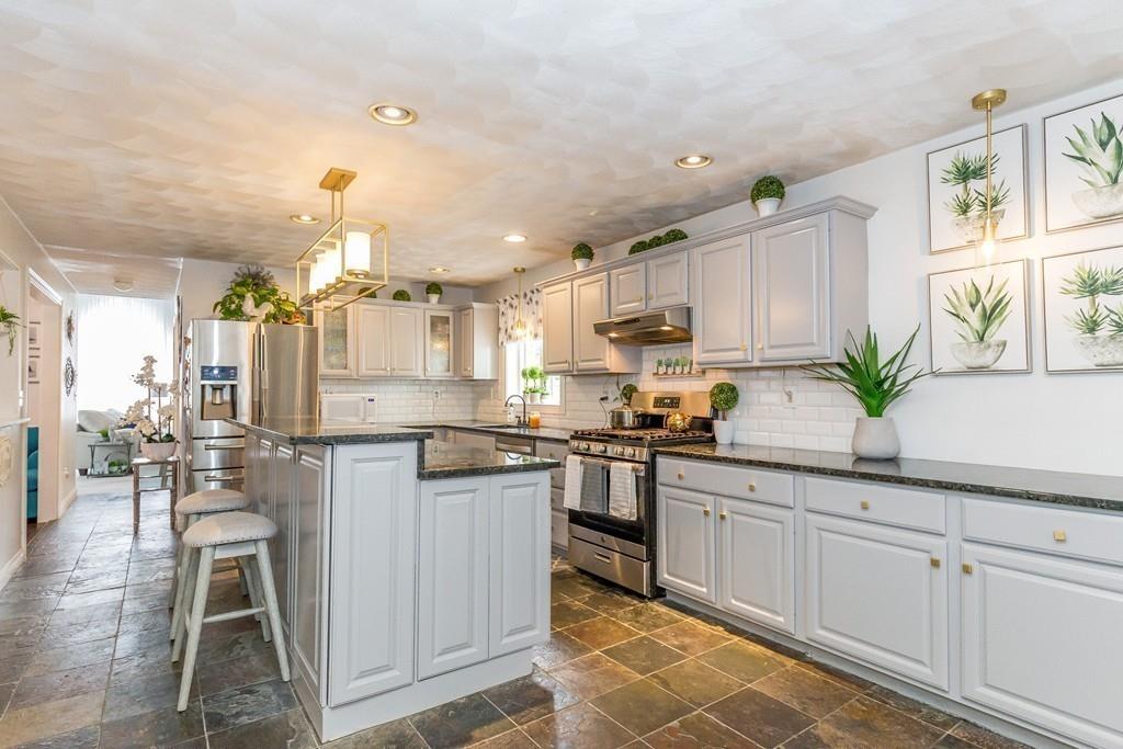 160 Scribner Road Tyngsborough, MA 01879 - Photo 9 of 31 a kitchen with white cabinets and sink