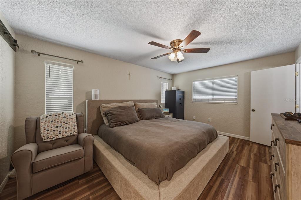 7435 Kilbride Court Weeki Wachee, FL 34613 - Photo 35 of 67 a bedroom with a large bed couch and a window
