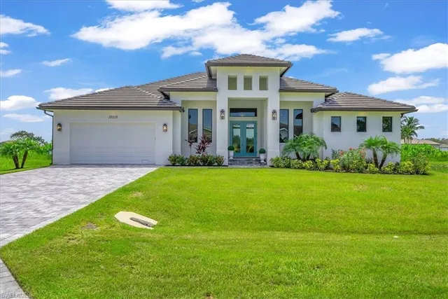 a front view of a house with a yard