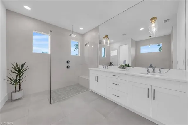 a bathroom with a double vanity sink and a mirror