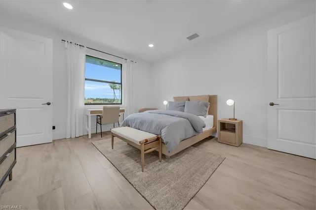 a bedroom with a bed and a window