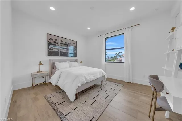 a spacious bedroom with a bed and a desk