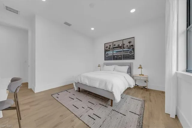 a bedroom with a bed and a painting on the wall