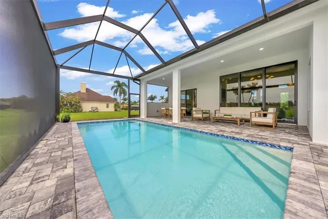 a view of swimming pool with outdoor seating
