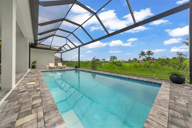 a view of a swimming pool with a yard