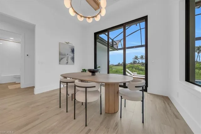 a view of a workspace room with wooden floor and windows