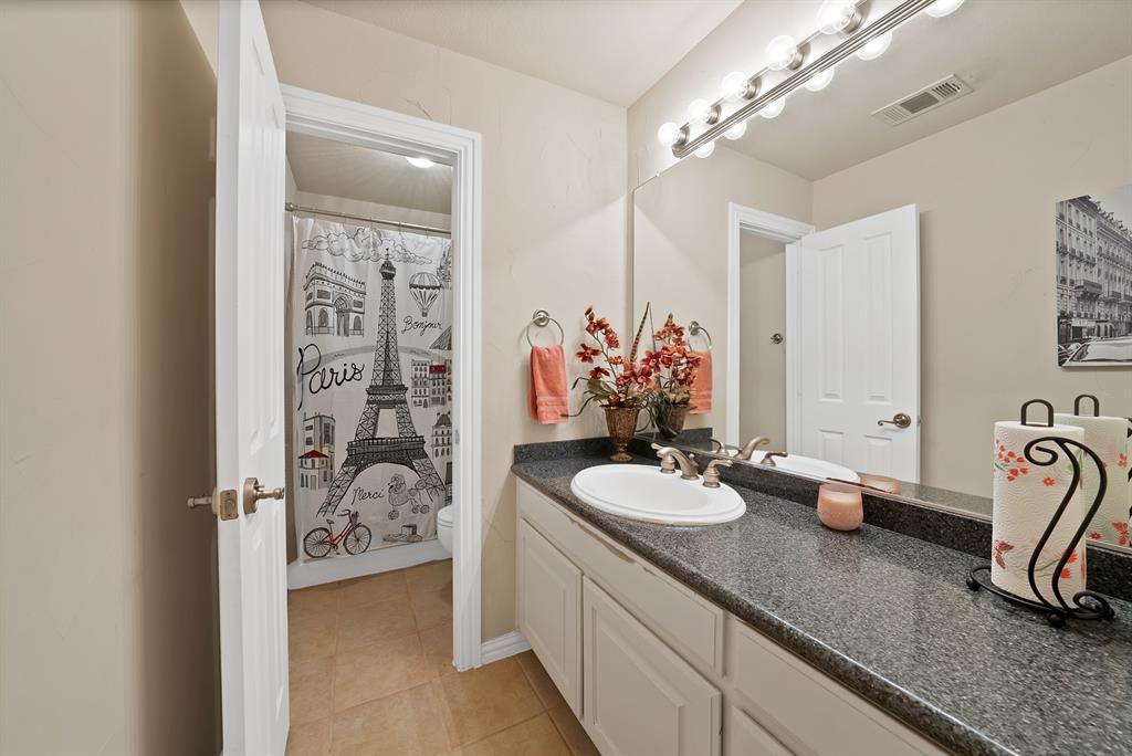 1014 Ricci Court Irving, TX 75062 - Photo 23 of 30 Full bath featuring vanity, light tile patterned floors, and a shower with curtain