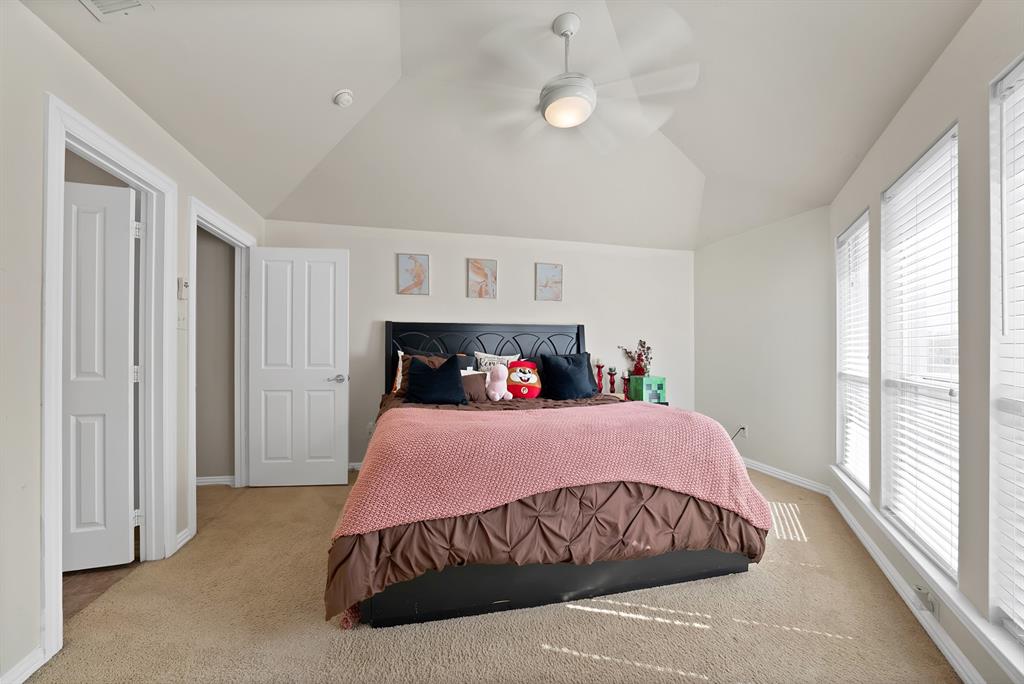 1014 Ricci Court Irving, TX 75062 - Photo 26 of 30 Carpeted bedroom featuring lofted ceiling and a ceiling fan