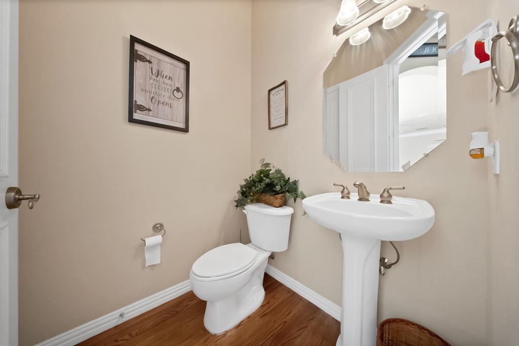 1014 Ricci Court Irving, TX 75062 - Photo 28 of 30 Bathroom with baseboards and wood finished floors