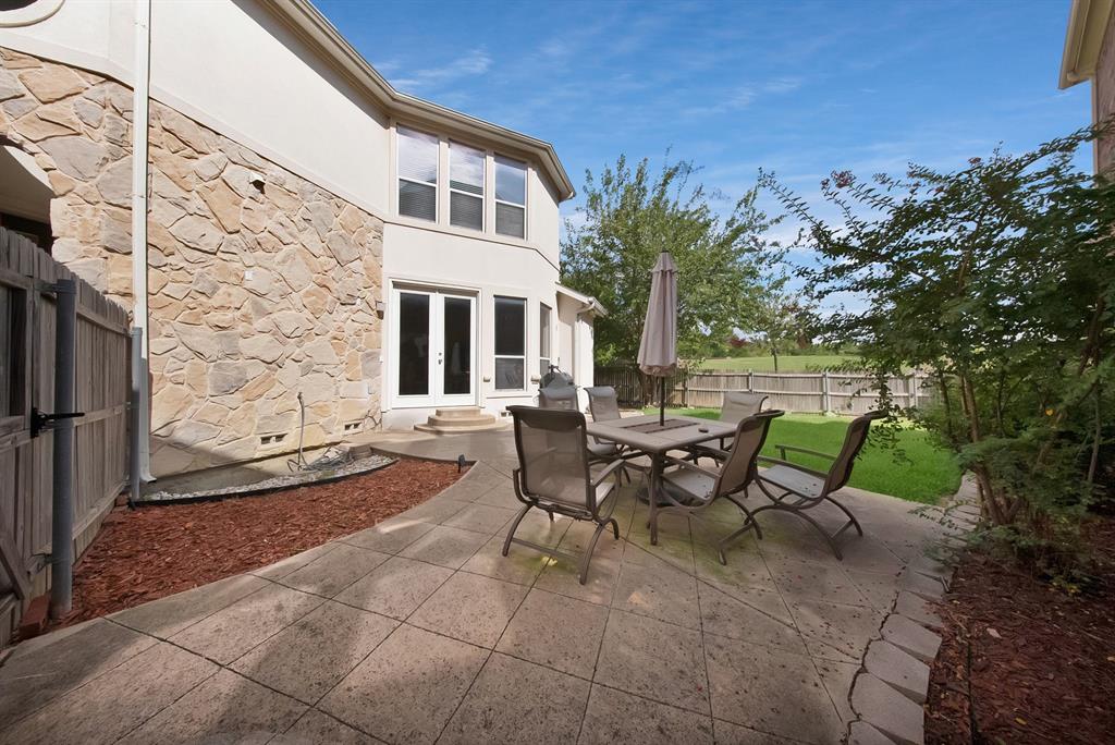 1014 Ricci Court Irving, TX 75062 - Photo 29 of 30 Fenced backyard featuring a patio, french doors, and outdoor dining area