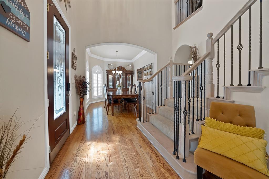 1014 Ricci Court Irving, TX 75062 - Photo 7 of 30 Entrance foyer with arched walkways, light wood-type flooring, ornamental molding, stairway, and a towering ceiling