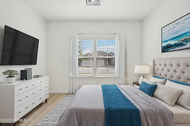 a bedroom with a bed and a flat screen tv in it