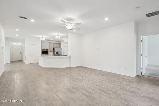 a view of a kitchen with a sink and a refrigerator