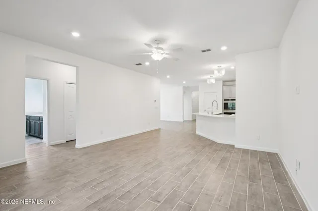 an empty room with windows and entrance