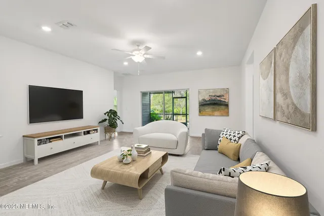 a living room with furniture and a flat screen tv