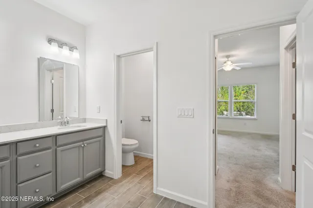 a view of a hallway with wooden floor and a window