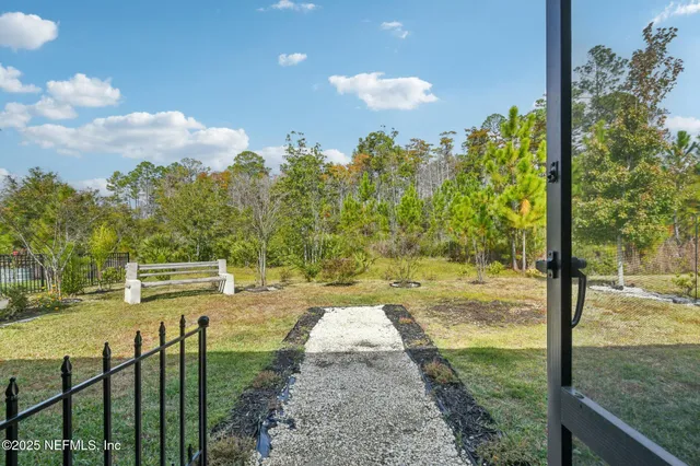 a view of a house with pool and chairs