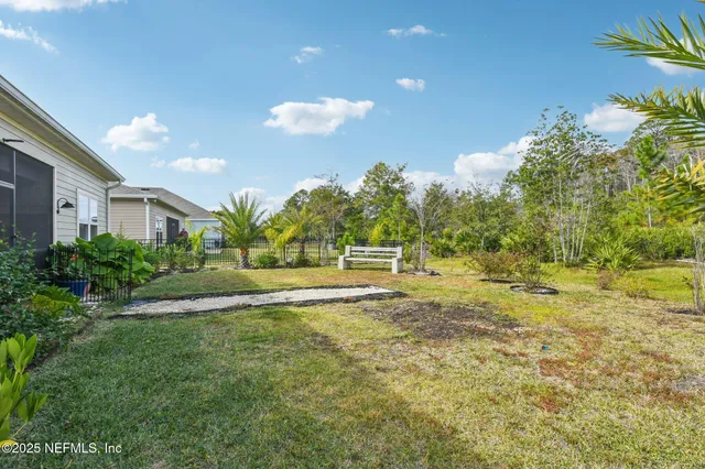 a view of a house with a small yard and a garden