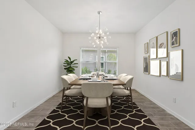 a dining room with furniture a chandelier and wooden floor