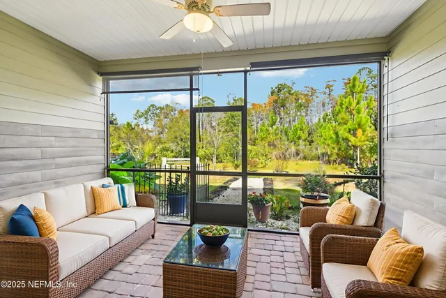 a balcony with furniture and a large window