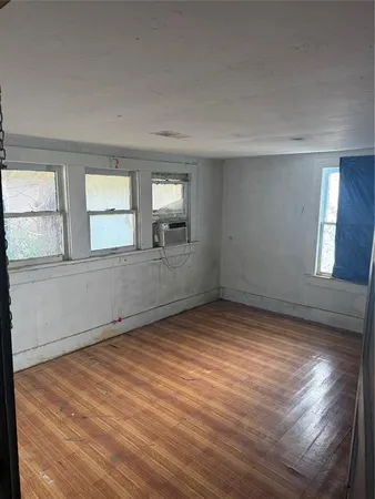 wooden floor in an empty room with window