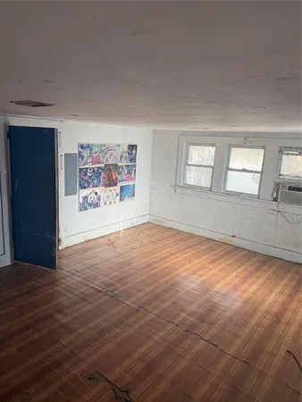 an empty room with windows and closet