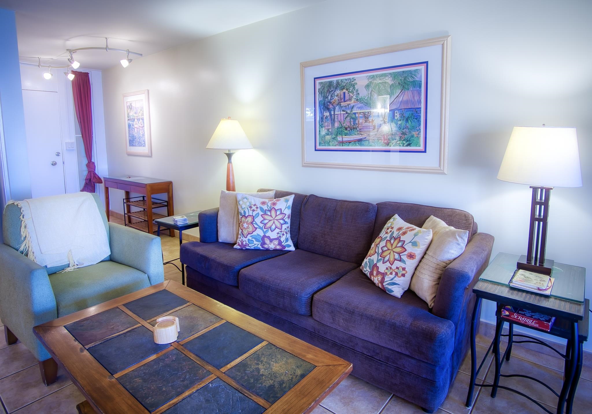 3823 Lower Honoapiilani Road, Unit 311 Lahaina, HI 96761 - Photo 12 of 20 a living room with furniture and a lamp