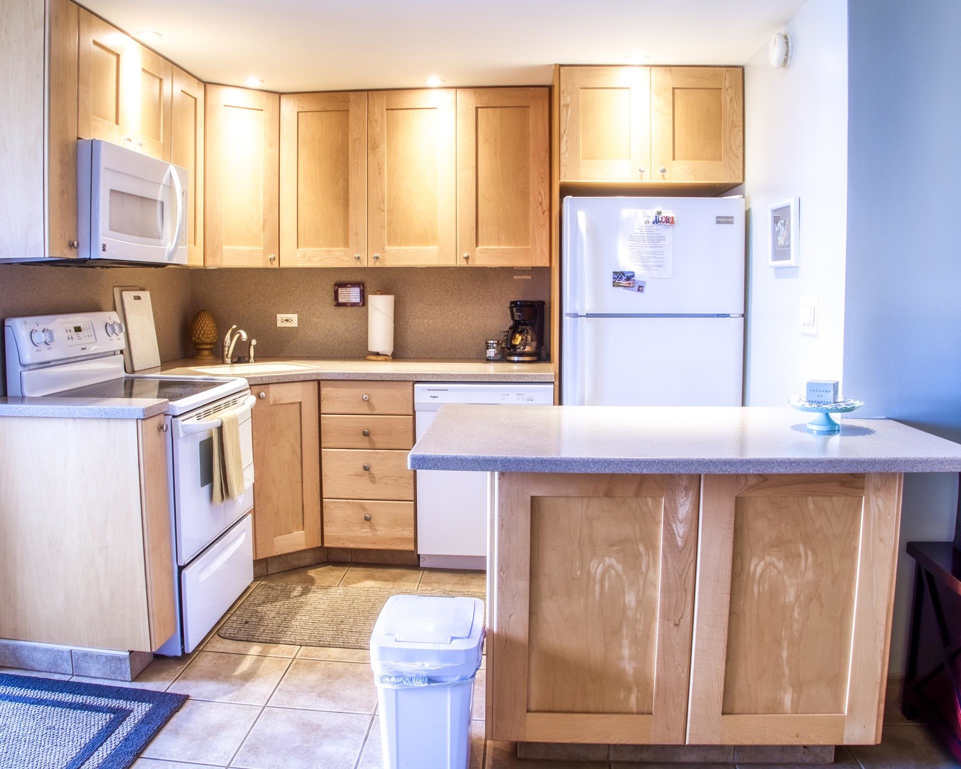 3823 Lower Honoapiilani Road, Unit 311 Lahaina, HI 96761 - Photo 3 of 20 a kitchen with a sink cabinets and window