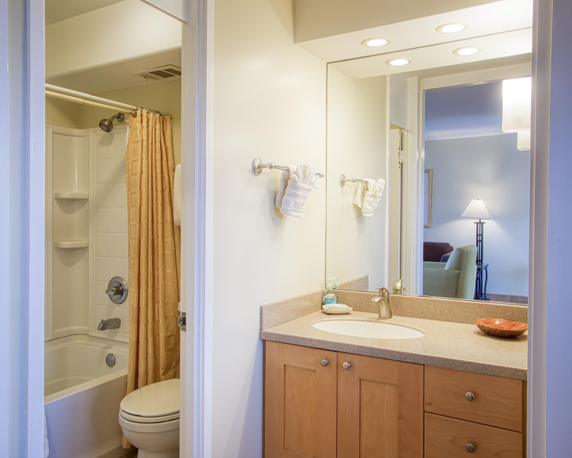 3823 Lower Honoapiilani Road, Unit 311 Lahaina, HI 96761 - Photo 6 of 20 a bathroom with a granite countertop sink toilet a shower and a mirror
