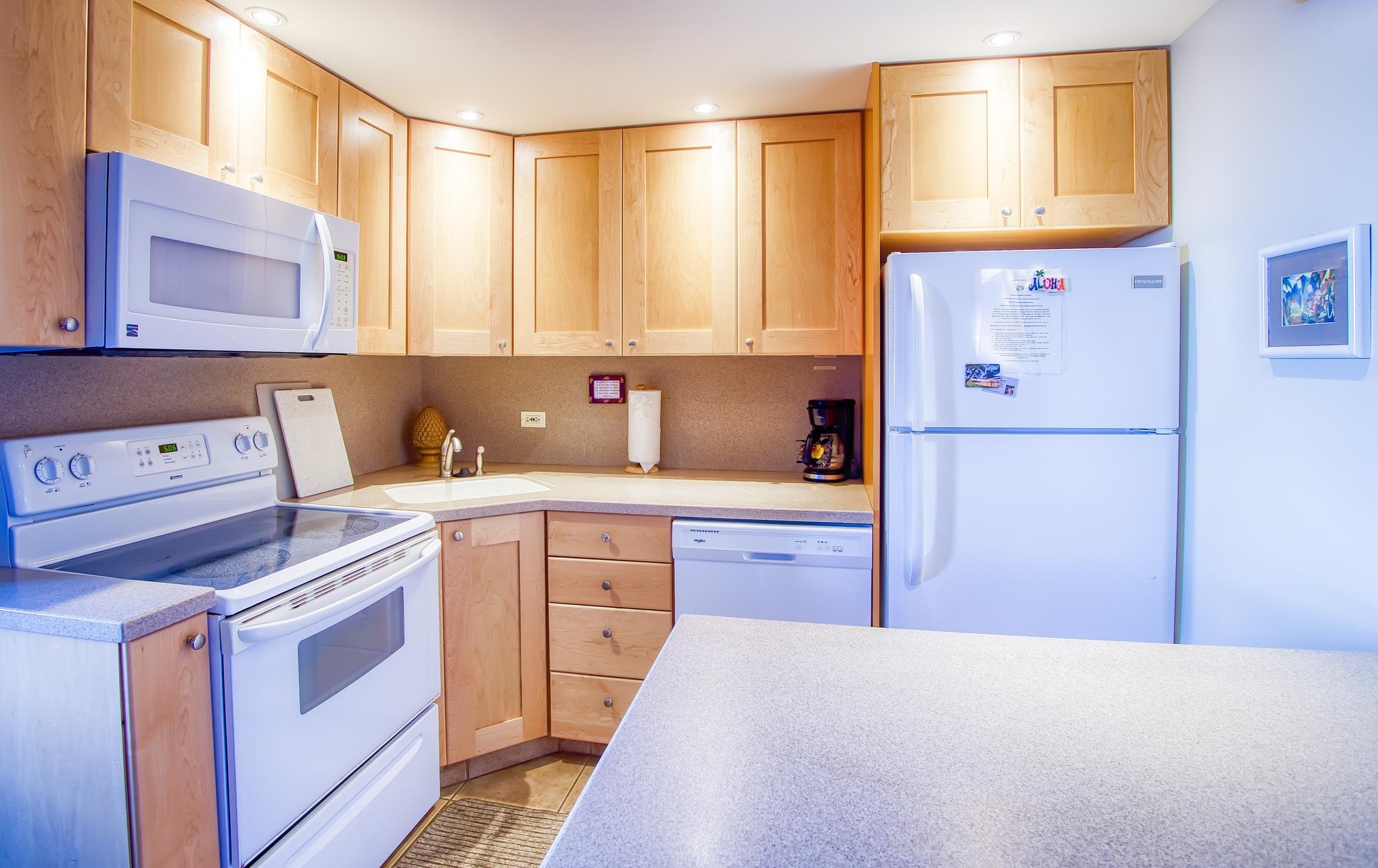 3823 Lower Honoapiilani Road, Unit 311 Lahaina, HI 96761 - Photo 7 of 20 a kitchen with cabinets appliances and a window
